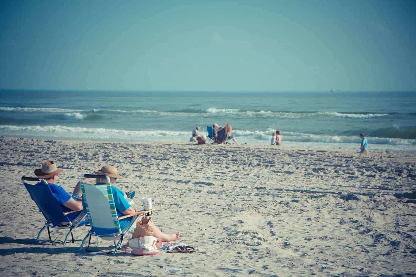 An older couple relaxing on a beach
